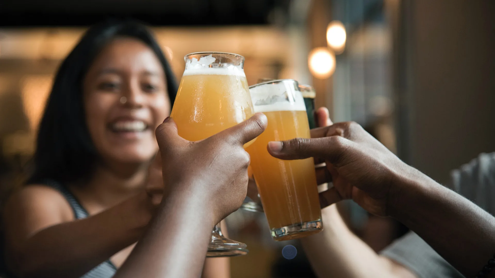 a group of people toasting with beer