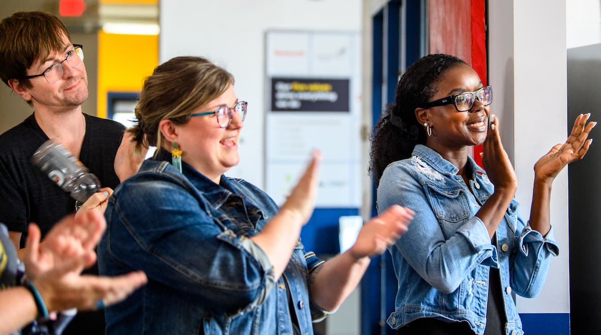 Clockwork employees smiling and clapping