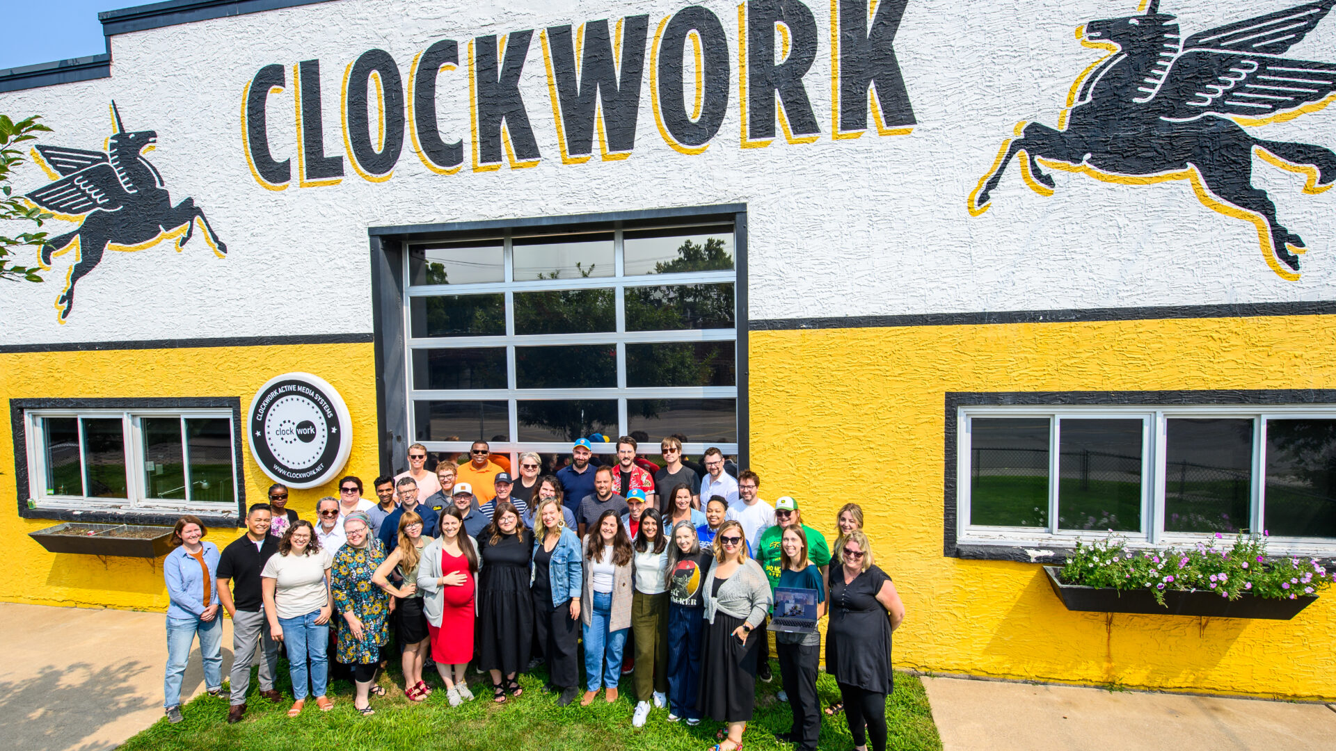 Clockwork Staff photo in front of our historic Rayvic building