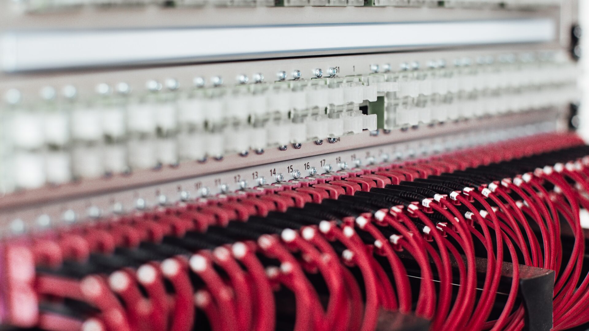 Server with many red cables connected to it representing data and connected systems for Industry 4.0 and service experience design