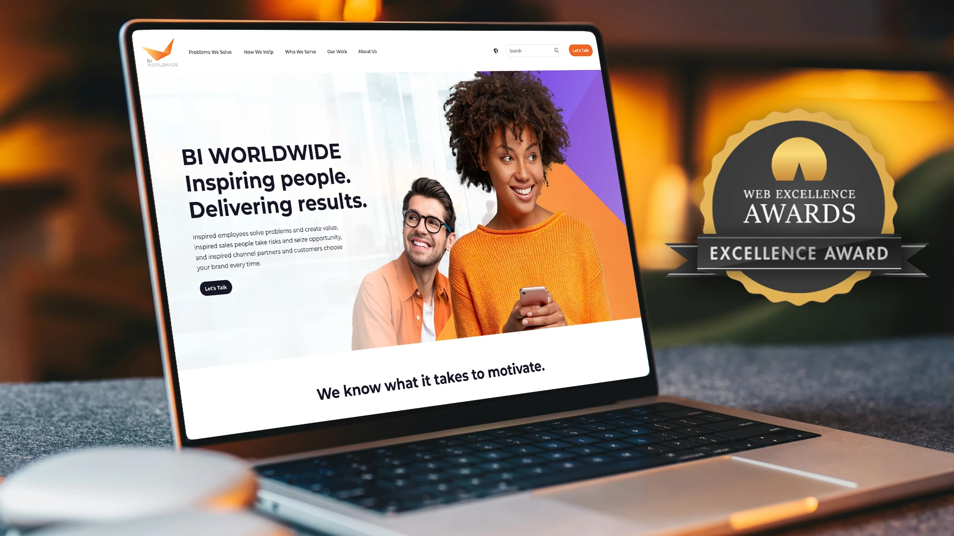 A laptop displays the global website for BI Worldwide, featuring two smiling people and the text Inspiring people. Delivering results. Next to the laptop is a Web Excellence Awards: Excellence Award badge.